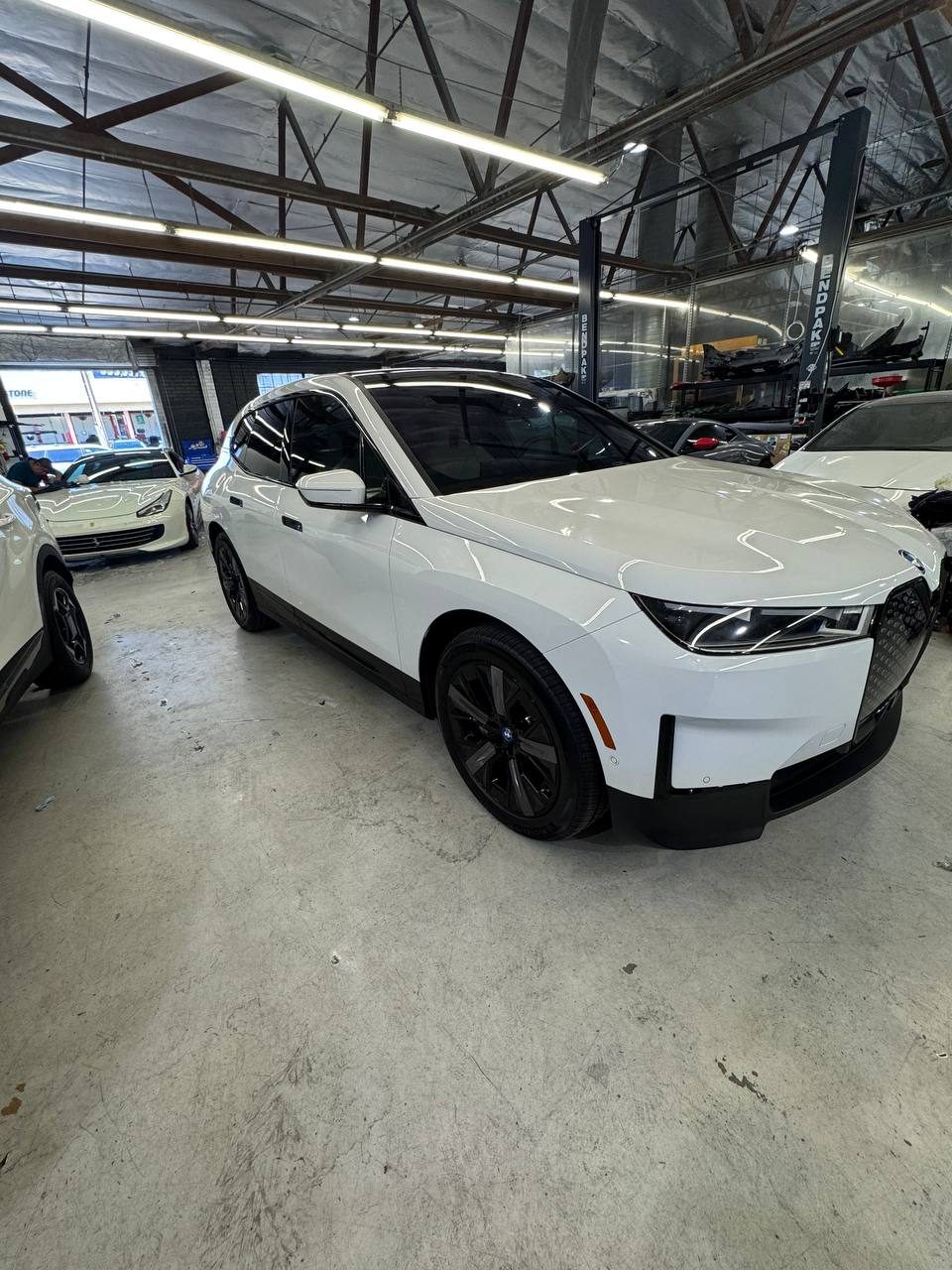 Freshly tinted white BMW iX at a mobile appointment
