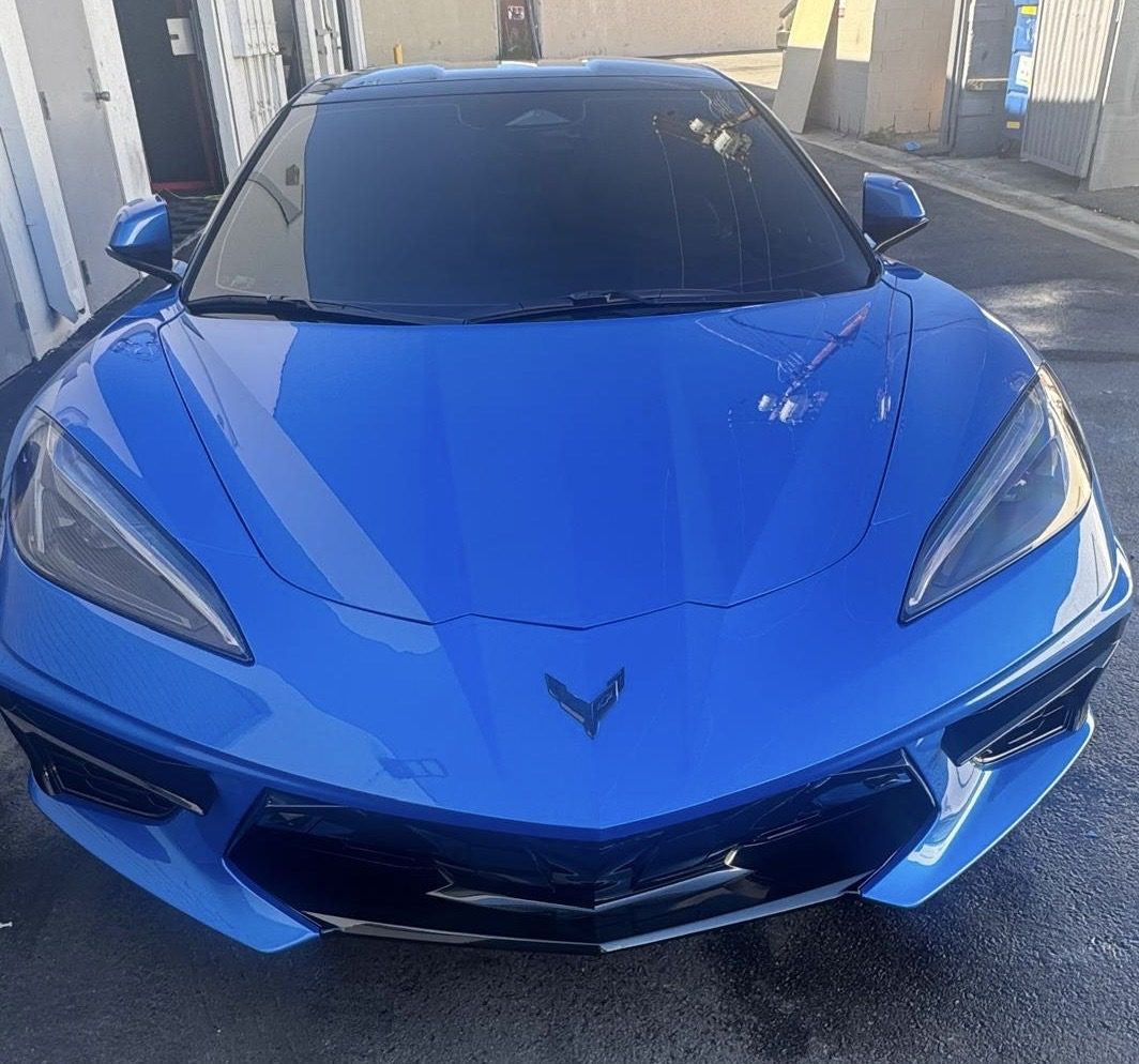 Blue Chevrolet Corvette C8 with tinted windshield