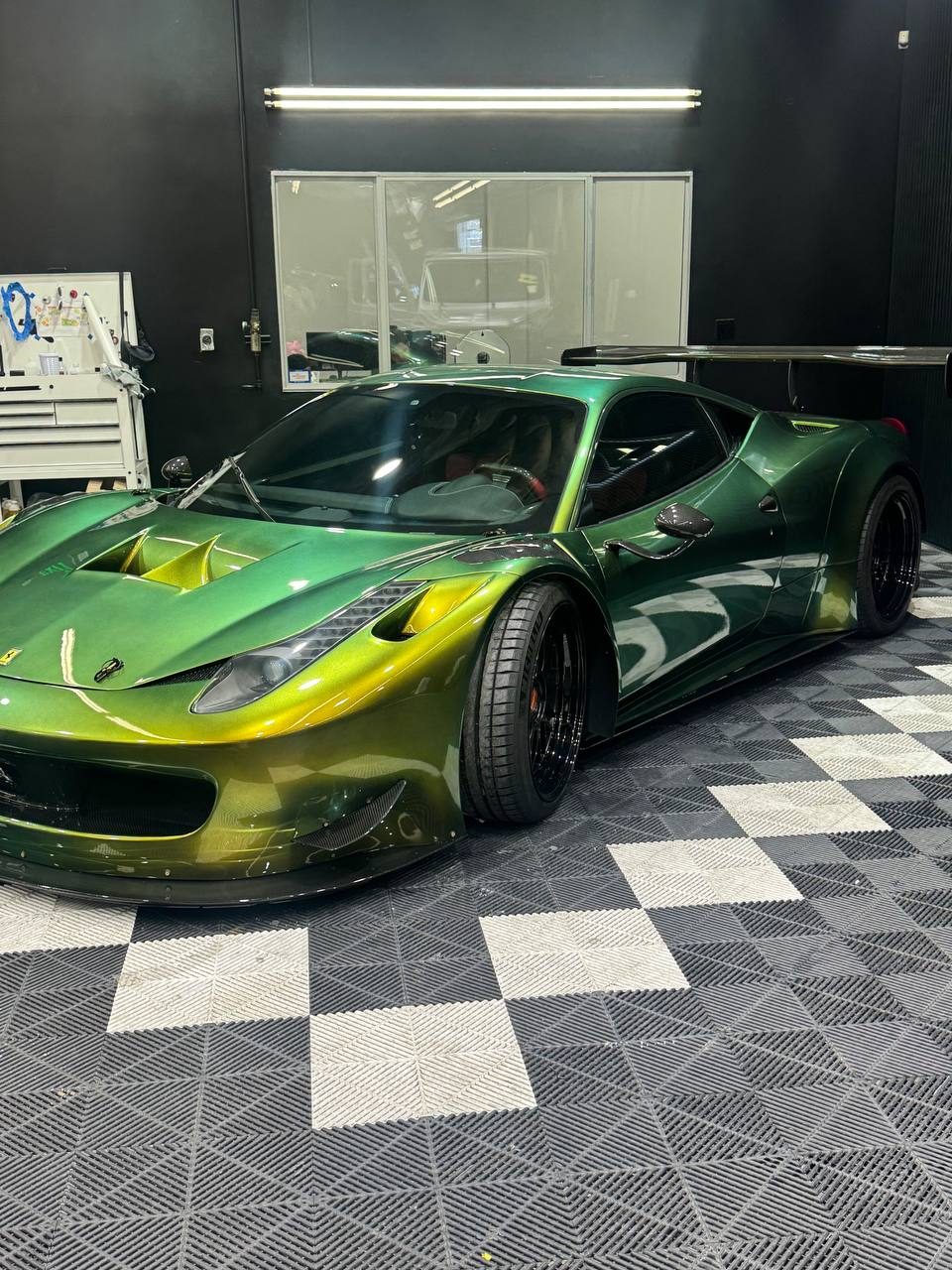 Green chameleon-wrapped Ferrari 458 with tinted windows