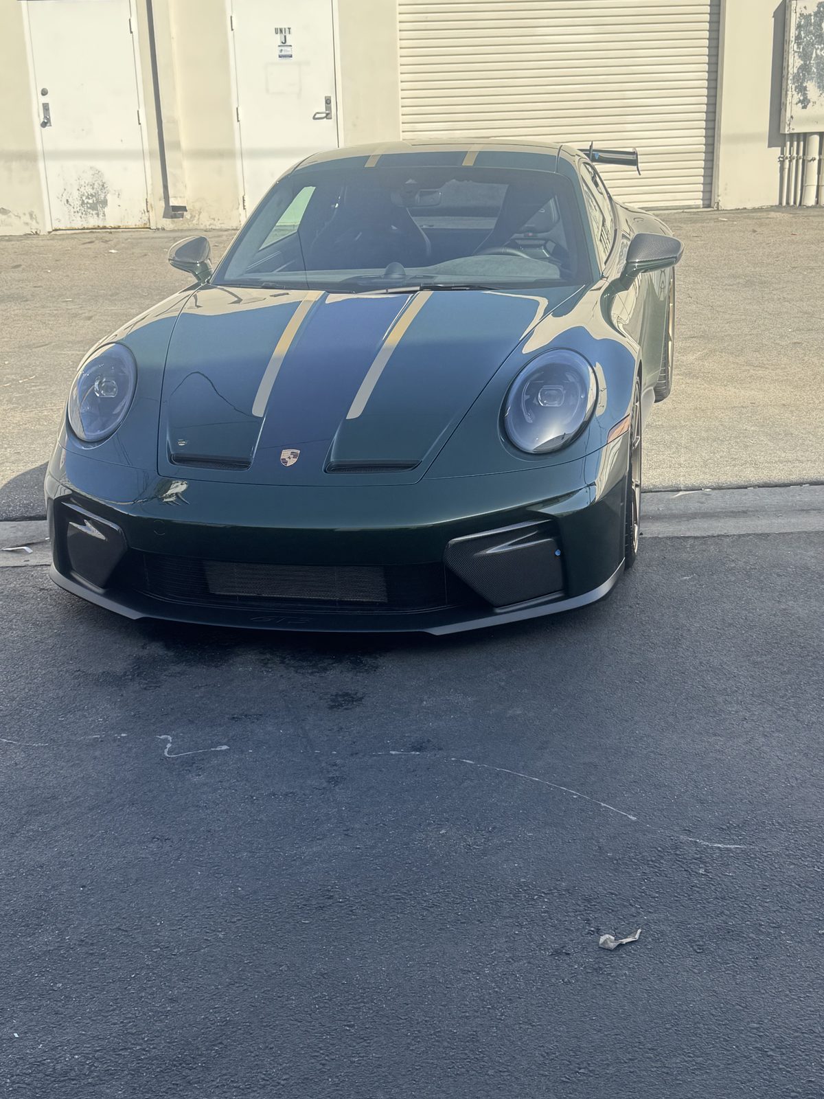 Green Porsche 911 GT3 with gold stripes and tinted glass