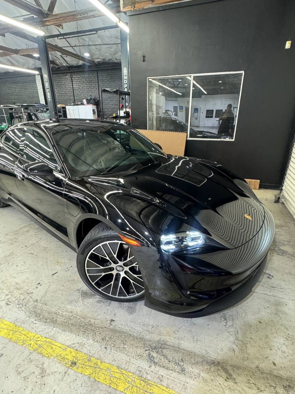 Black Porsche Taycan with full ceramic tint