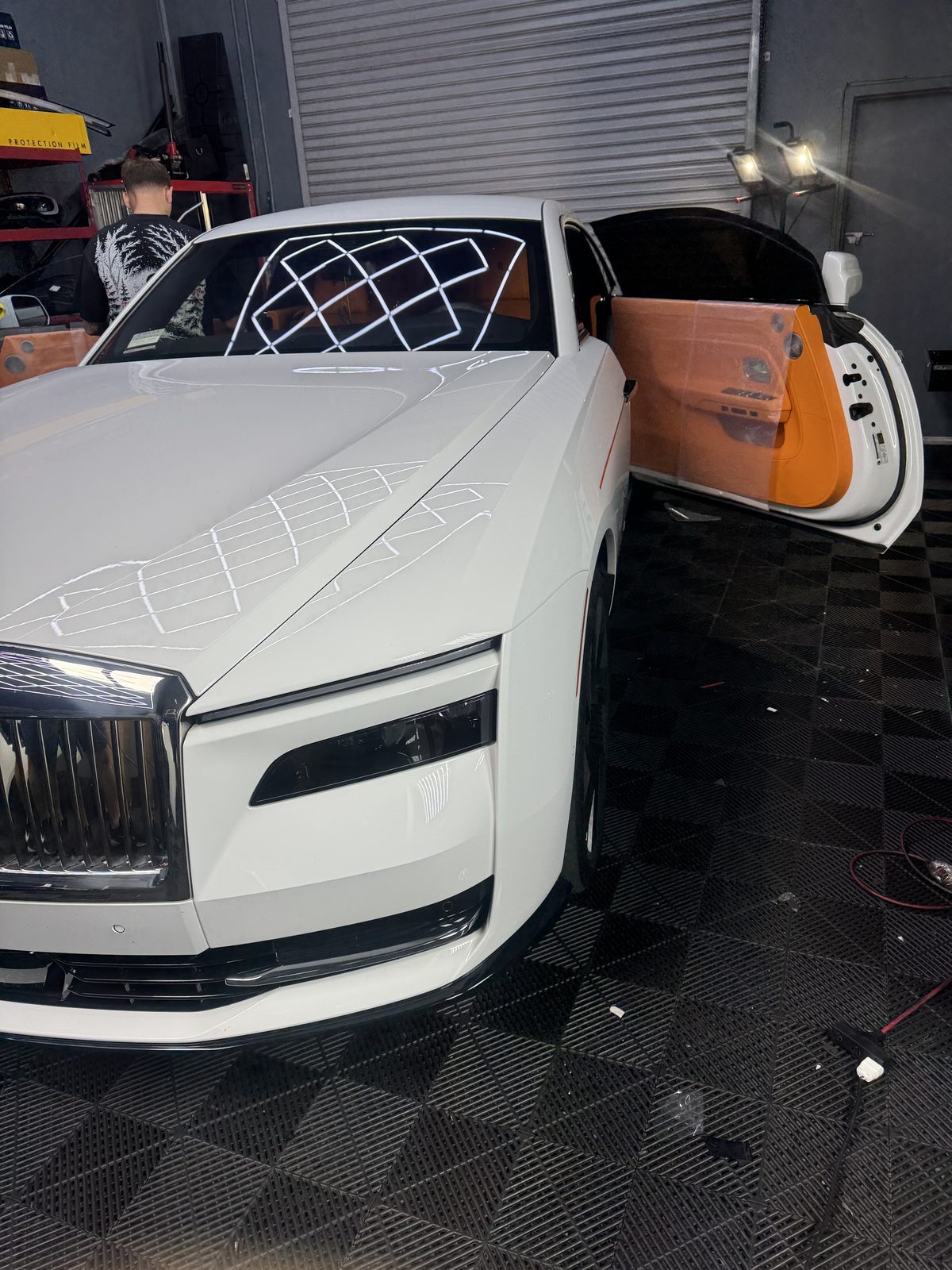White Rolls-Royce Spectre during window tint installation